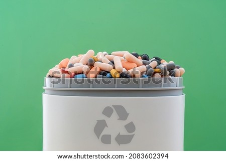 Full of expired pills and medicines in the trash bin with recycling symbol. Waste pills collected to be recycled. waste management concept. Royalty-Free Stock Photo #2083602394