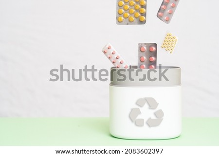 Full of expired pills and medicines in the trash bin with recycling symbol. Waste pills collected to be recycled. waste management concept. Royalty-Free Stock Photo #2083602397