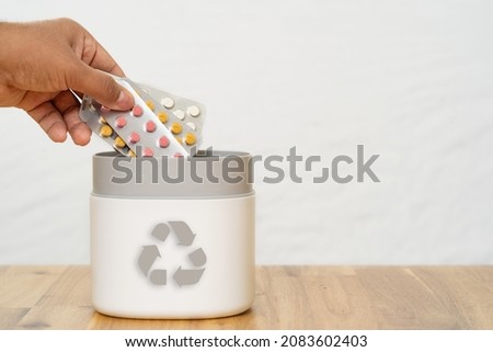 Full of expired pills and medicines in the trash bin with recycling symbol. Waste pills collected to be recycled. waste management concept. Royalty-Free Stock Photo #2083602403