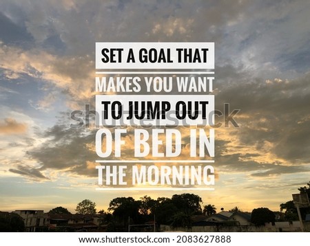 Motivational quote written with phrase SET A GOAL THAT MAKES YOU WANT TO JUMP OUT OF BED IN THE MORNING Royalty-Free Stock Photo #2083627888