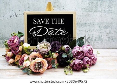 Save the Date typography text with Flower bouquet on wooden background
