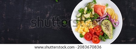 Salt salmon salad with tomatoes, cucumbers, scrambled eggs and avocado. Ketogenic diet breakfast. Keto lunch. Top view, banner