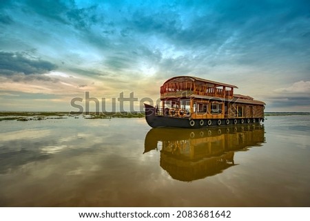 Travel tourism Kerala background - houseboat on Kumarakom backwaters,India.Kerala houseboat image Royalty-Free Stock Photo #2083681642