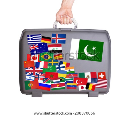 Used plastic suitcase with lots of small stickers, large sticker of Pakistan