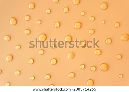 Flatlay top view sweet Honey texture drop round shape on plain light orange yellow color background. Skincare ingredient for antibacterial and suitable for acne prone oily sensitive or all skin types Royalty-Free Stock Photo #2083714255