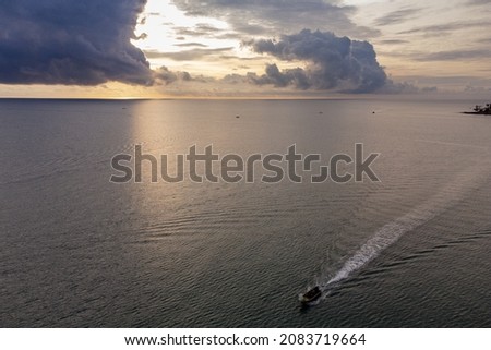 sunset on the sea horizon while as ships passed on the sea