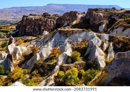 Astonishing landscape view of geologic formations of Cappadocia. Amazing shaped sandstone rocks. Famous touristic place and romantic travel destination. Picturesque autumn view.