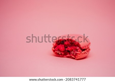 pink macaroon on a pink background. delicious fresh dessert. monochrome. color of the year.