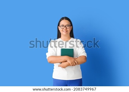 Asian female teacher on color background