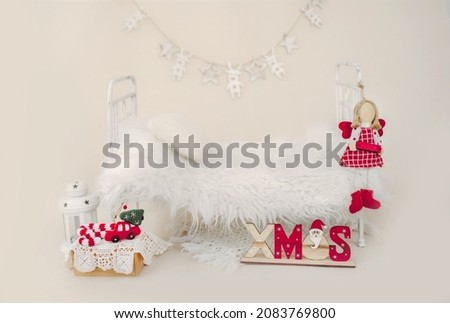 Newborn baby studio furniture bed for Christmas infant child photoshoot with fur and Xmas decoration. Tiny designed scene for kid New Year holiday studio portrait