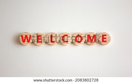 Welcome and support symbol. The concept word Welcome on wooden circles. Beautiful white background, copy space. Business, welcome and support concept.