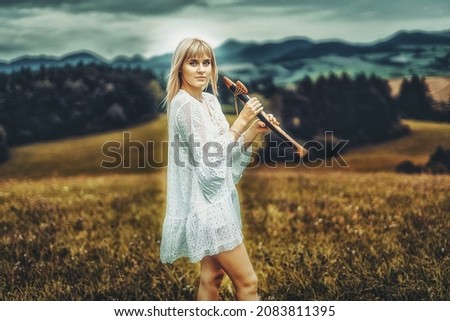 girl playing on shaman flute in the nature
