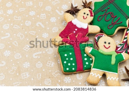 Selection of delicious homemade Christmas gingerbread cookies on brown holiday background with copy space