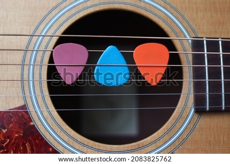Picks on Acoustic Guitar Strings. Music learning and performance activities concept