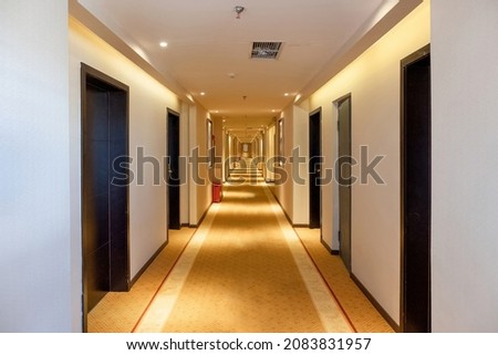 Nobody of hallway straight with the door and golden lighting illuminated in the hotel