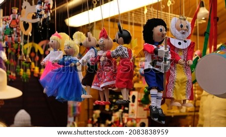 Traditional wooden puppet toys hang at a market stalls in Prague, Czech Republic. Marionette Puppet toys - king and boy hockey player. Royalty-Free Stock Photo #2083838959