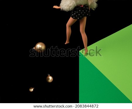 Girl doll and bubles on black and green pastel background. Christmas fashion concept.