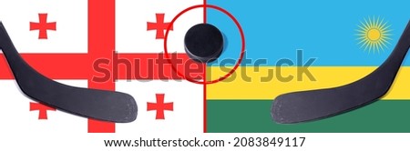 Top view hockey puck with Georgia vs. Rwanda command with the sticks on the flag. Concept hockey competitions