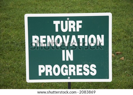 green sign with white letter - TURF RENOVATION IN PROGRESS
