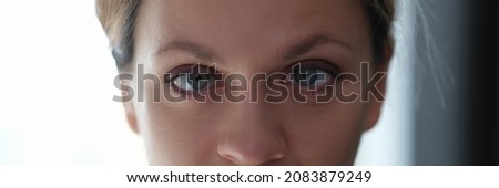 Portrait of young beautiful woman with squint eyes Royalty-Free Stock Photo #2083879249