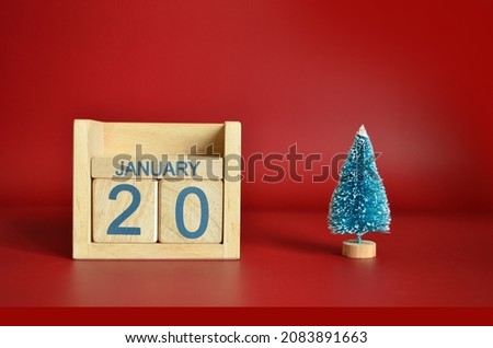 January 20, Calendar design with Christmas tree on red table background.