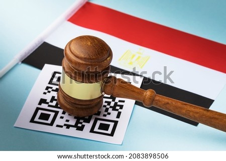 Judge gavel, barcode sheet and Egyptian flag, the concept of administrative punishment for violation of the regime using QR codes in Egypt Royalty-Free Stock Photo #2083898506