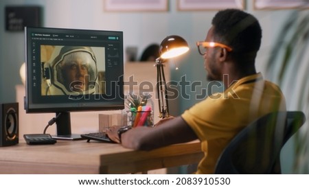 African American guy retouching photo of cosmonaut