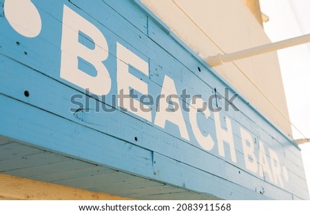 Beach bar sign on a blue wooden planks