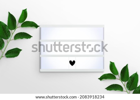 Tree branches with green leaves and Lightbox with heart on a white background. Advertising board, poster mockup for your design. Flat lay, top view, copy space