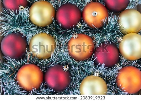 flat lay with gold, red and orange Christmas balls. Christmas background. New Year or Xmas concept. Top view. Close up