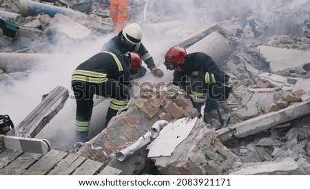 Emergency workers removing rubble together Royalty-Free Stock Photo #2083921171