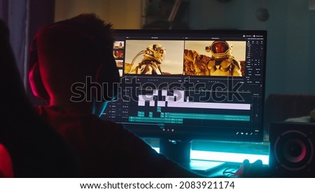 Teenager editing video on computer