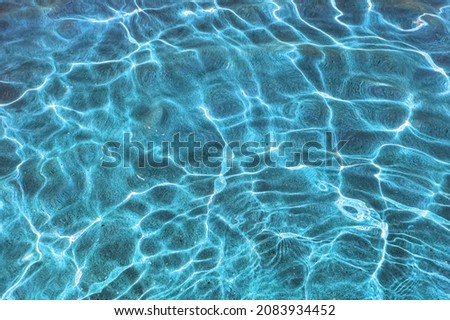 Marine background texture of sun glare through the water column reflected on the sandy seabed Royalty-Free Stock Photo #2083934452