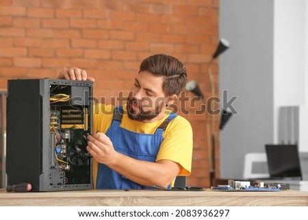 Technician repairing computer in service center