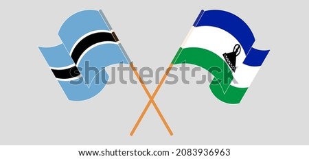 Crossed and waving flags of Botswana and Kingdom of Lesotho. Vector illustration
