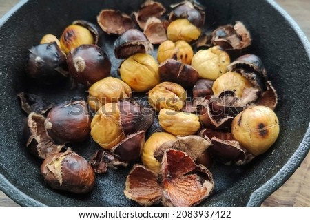 Roasted chestnuts in a grated pan