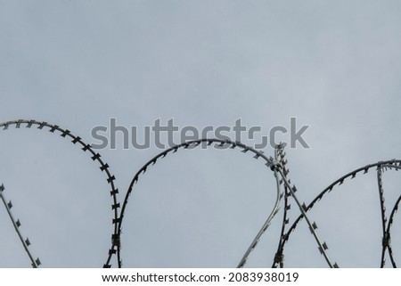Razor wire on the border between the two countriesv
