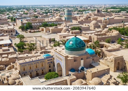 Panorama of historical center of Khiva (Uzbekistan) - Ichan-Kala (inner city). In foreground is mausoleum of Pahlavan Mahmoud. Background: Kalta Minor minaret, khan's palace and Muhammad Amin madrasah Royalty-Free Stock Photo #2083947640