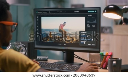 African American man editing video with chromakey background