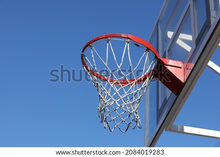 Basketball hoop with net outdoors on sunny day, space for text