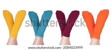Female legs in colorful socks on white background