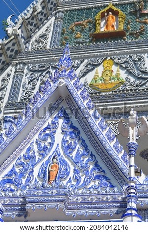 View of the beautiful ceramic gable inside compound of Blue church, Wat Pak Nam Khaem Nu Temple, Chathaburi, Thailand. Royalty-Free Stock Photo #2084042146