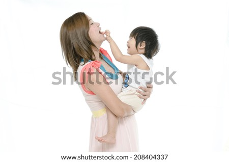 Asian mother and baby kissing, laughing and hugging