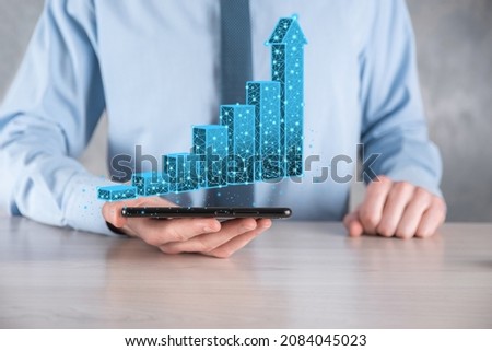 Business man holding 3D graphs low polygonal and stock market statistics gain profits. Concept of growth planning,business strategy.economic growing concept.Business strategy. Digital marketing