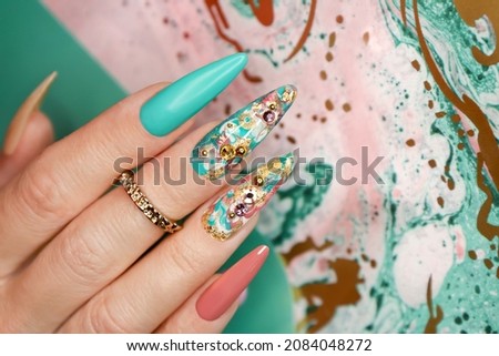 Creative color manicure with rhinestones on long nails. Royalty-Free Stock Photo #2084048272