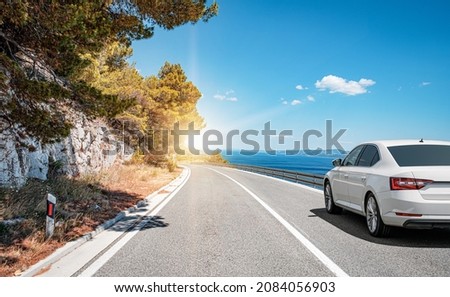 Car on the highway along the sea coast. Vacation or car rental concept. Royalty-Free Stock Photo #2084056903