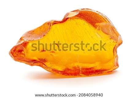 Natural amber. A piece of yellow opaque natural amber on white background. Royalty-Free Stock Photo #2084058940