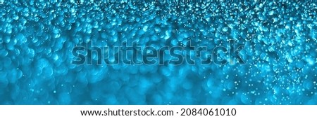 Blue sparkling glitter bokeh background texture. Holiday lights. Abstract defocused header. Wide screen wallpaper. Panoramic web banner with copy space for design