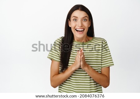 Happy caucasian woman clapping, applause and look amazed at camera, standing over white background