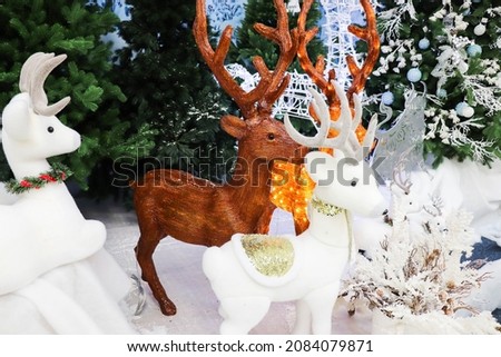 christmas reindeer near the christmas tree 